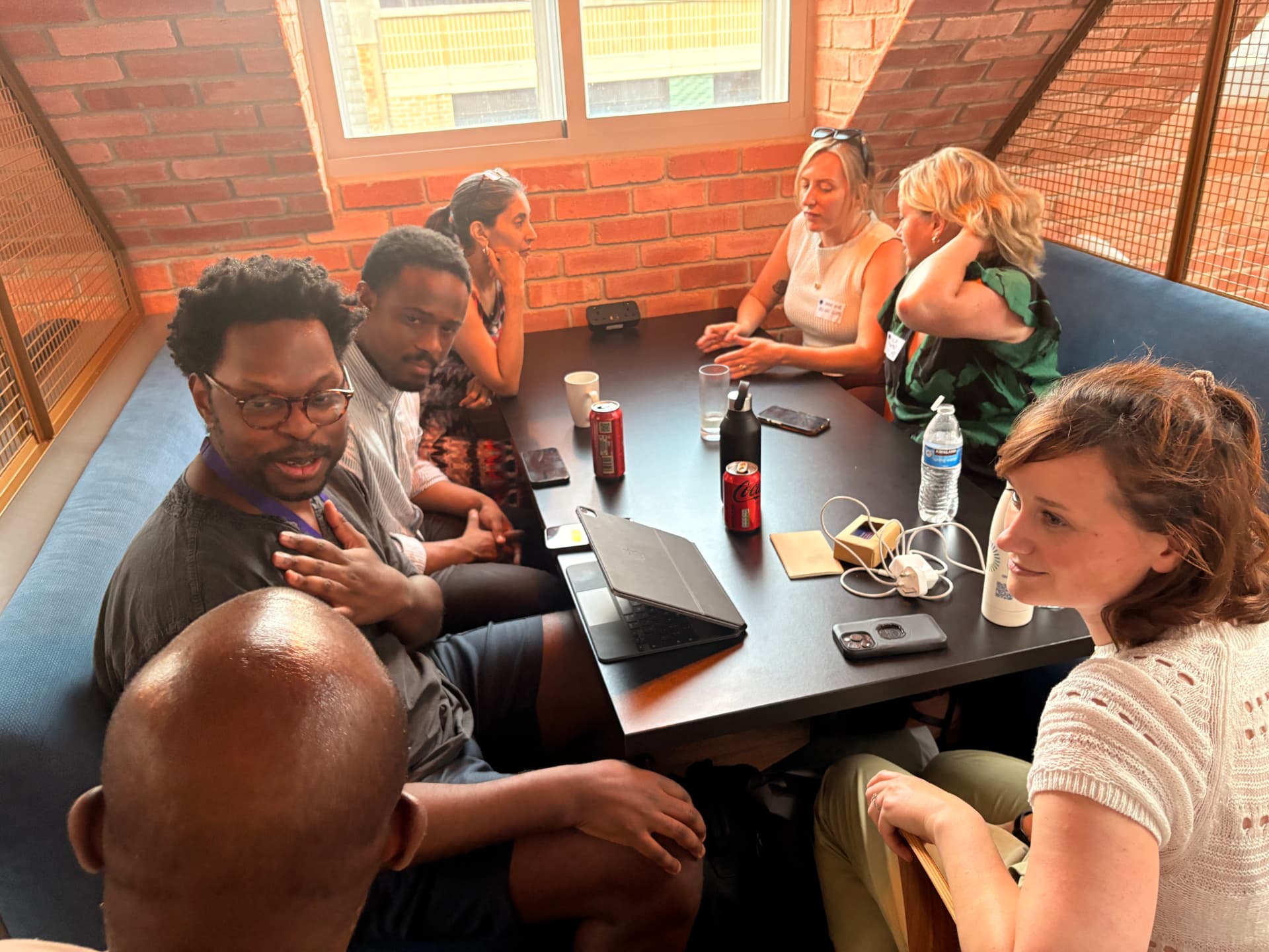 Members in conversation around a table at a networkd workshop