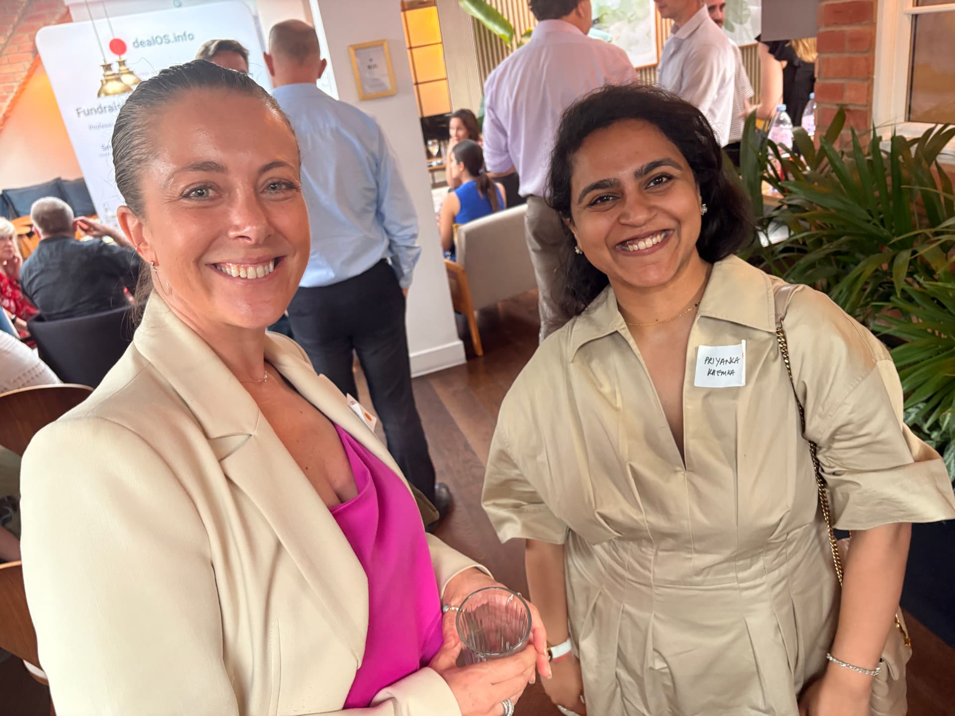 Two members smiling for a photo at a networkd event