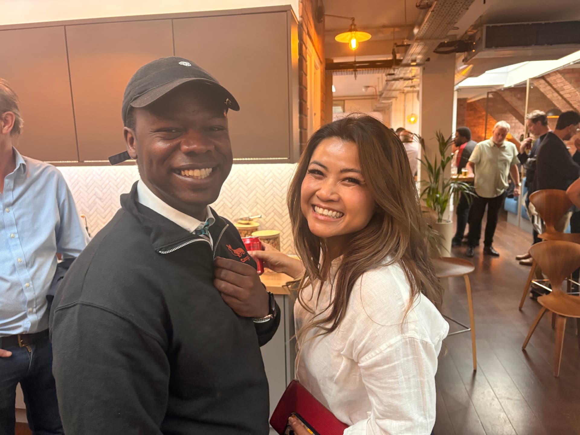Two members smiling and chatting at a networkd meetup