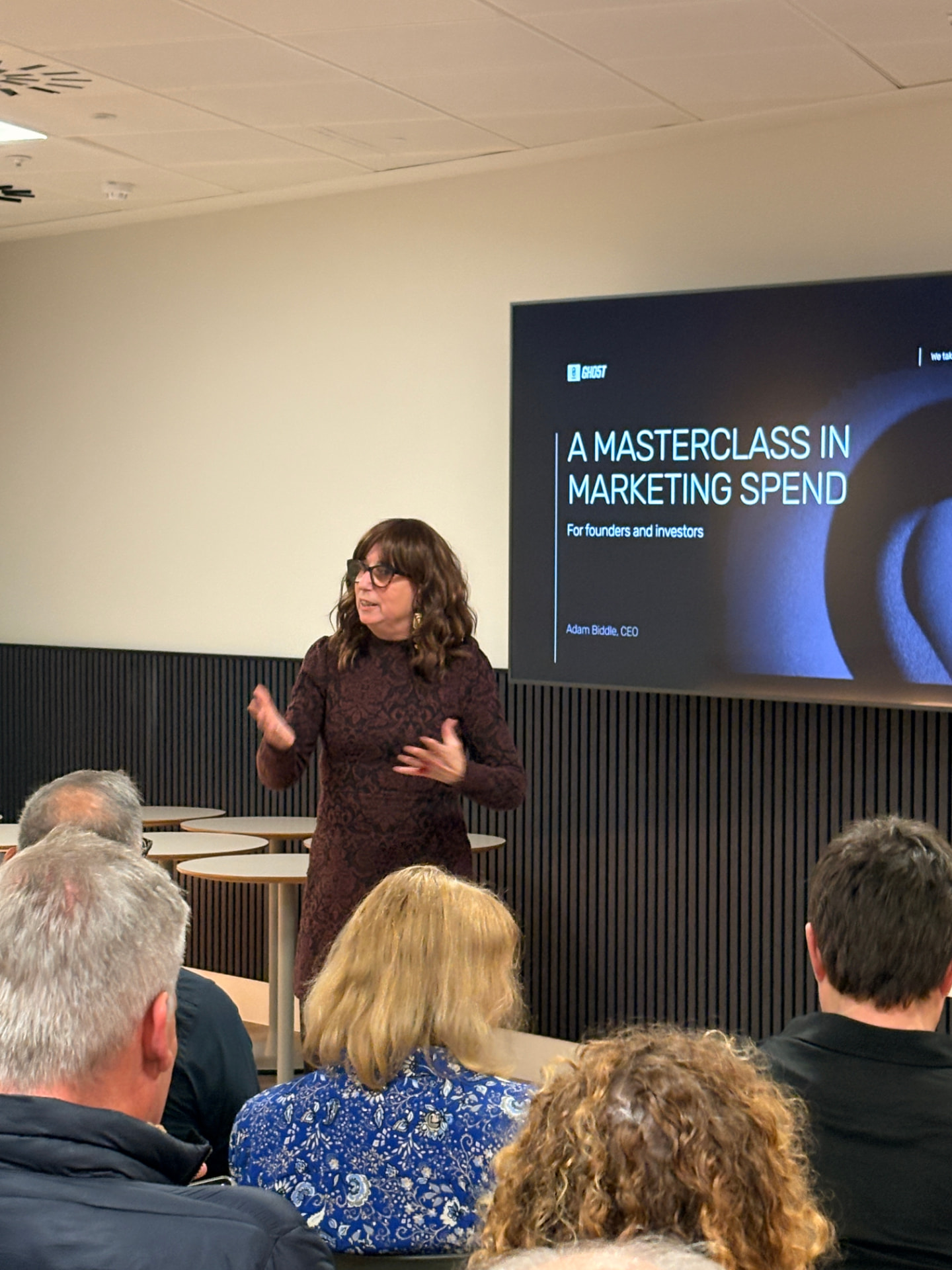 A speaker presenting to a seated audience at a networkd session