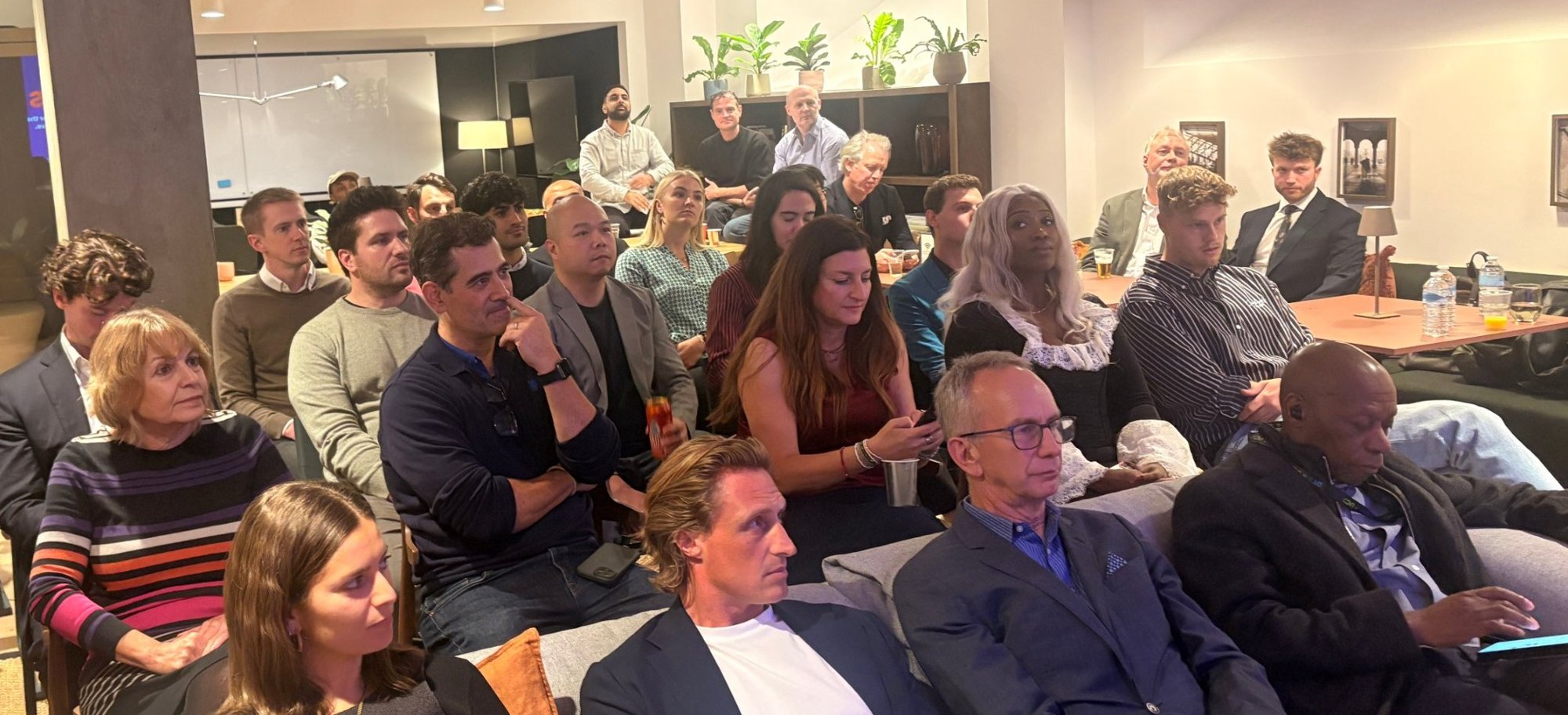 A full room of founders, investors and mentors listening at a networkd event