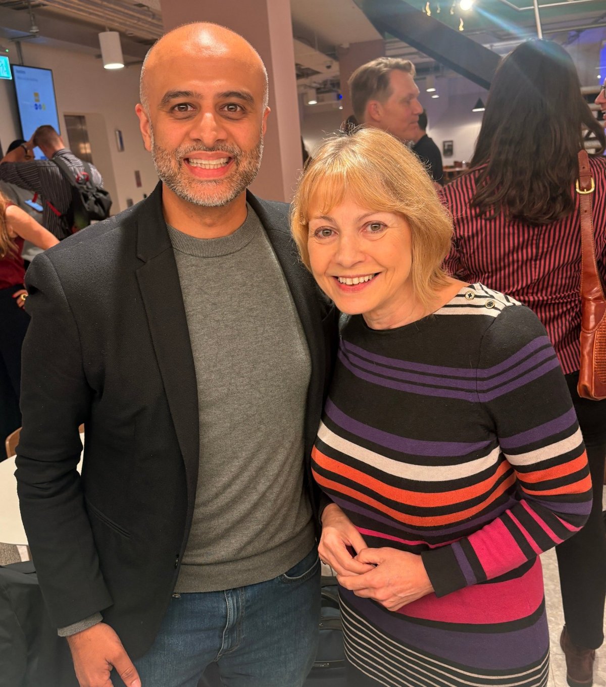 Two networkd members smiling together at an event